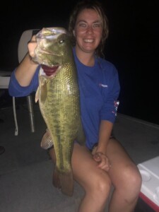 Women at night with bass fish