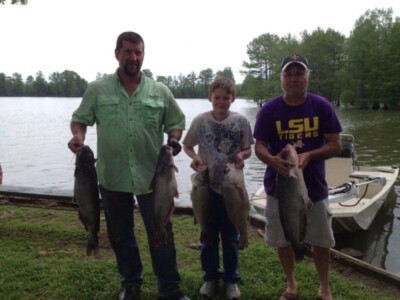 Three men holding catch at Lakeview Lodge