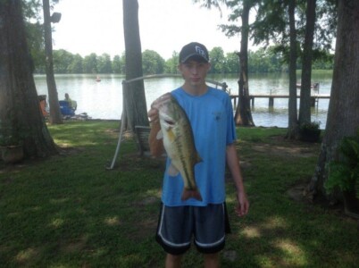 Young man and large mouth bass